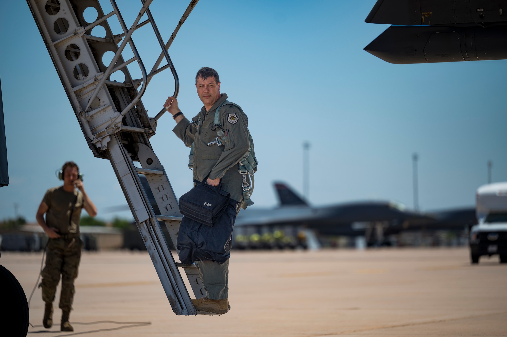 Maj. Gen. Andrew Gebara, 8th Air Force and Joint-Global Strike Operations Center commander, exits a B-1B Lancer flight after accompanying 9th Bomb Squadron personnel at Dyess Air Force Base, Texas, April 29, 2022. The 8th Air Force command team used the visit as an opportunity to discuss the importance of Striker Airmen and the role they play in support of the global strike mission. (U.S. Air Force photo by Airman 1st Class Josiah Brown)