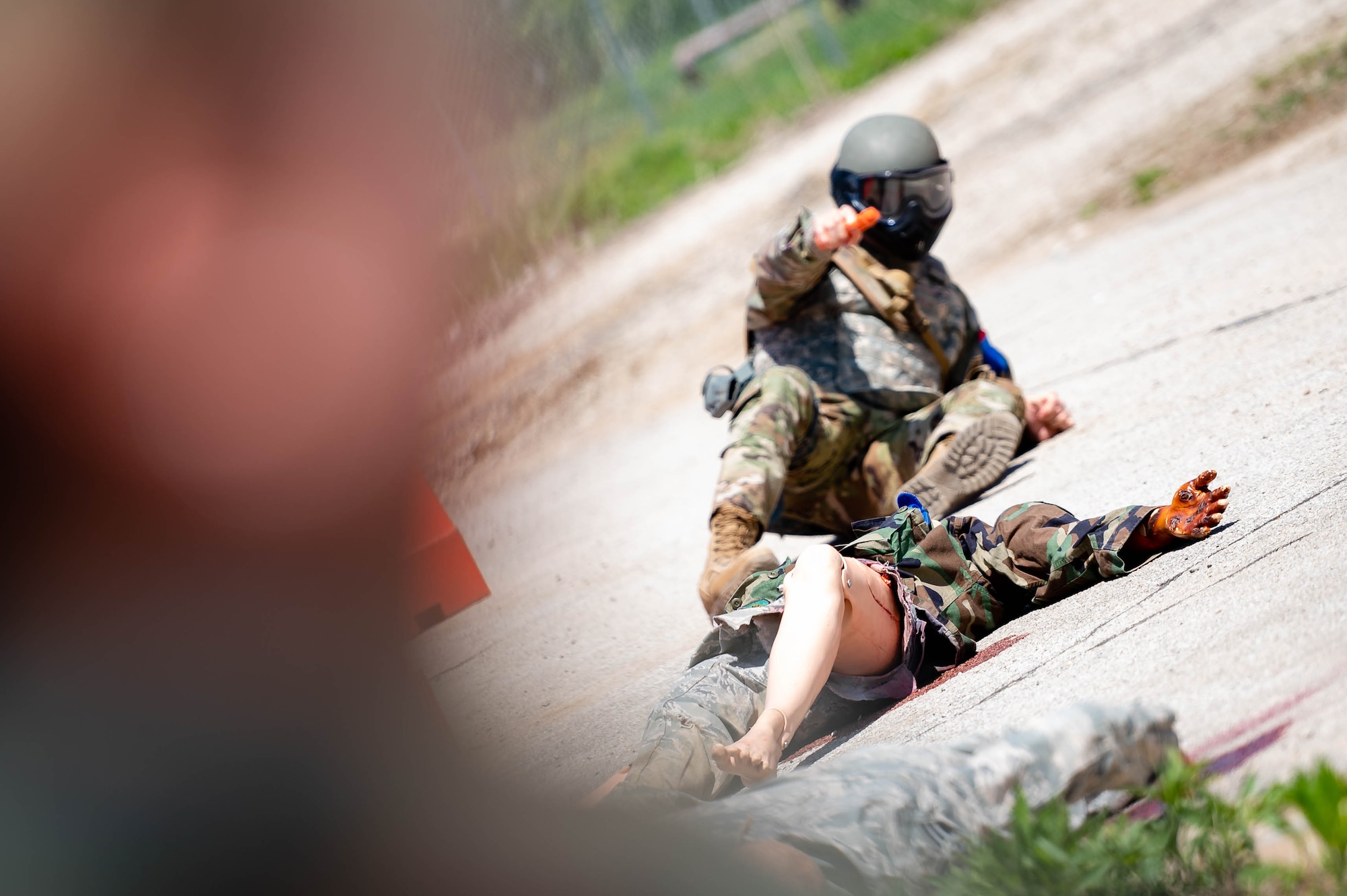 Man points gun while on the ground.