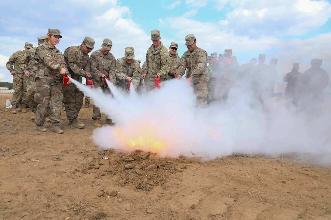 Soldiers extinguish a fire.