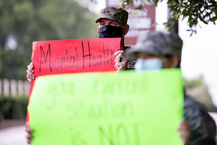 Airman from the 42nd Medical Operations Squadron mental health clinic held signs outside the Day Street gate for Mental Health Awareness Month, May 28, 2020, Maxwell Air Force Base, Alabama. The signs featured various inspiring sayings in regards to mental health. (U.S. Air Force photo by Senior Airman Alexa Culbert)