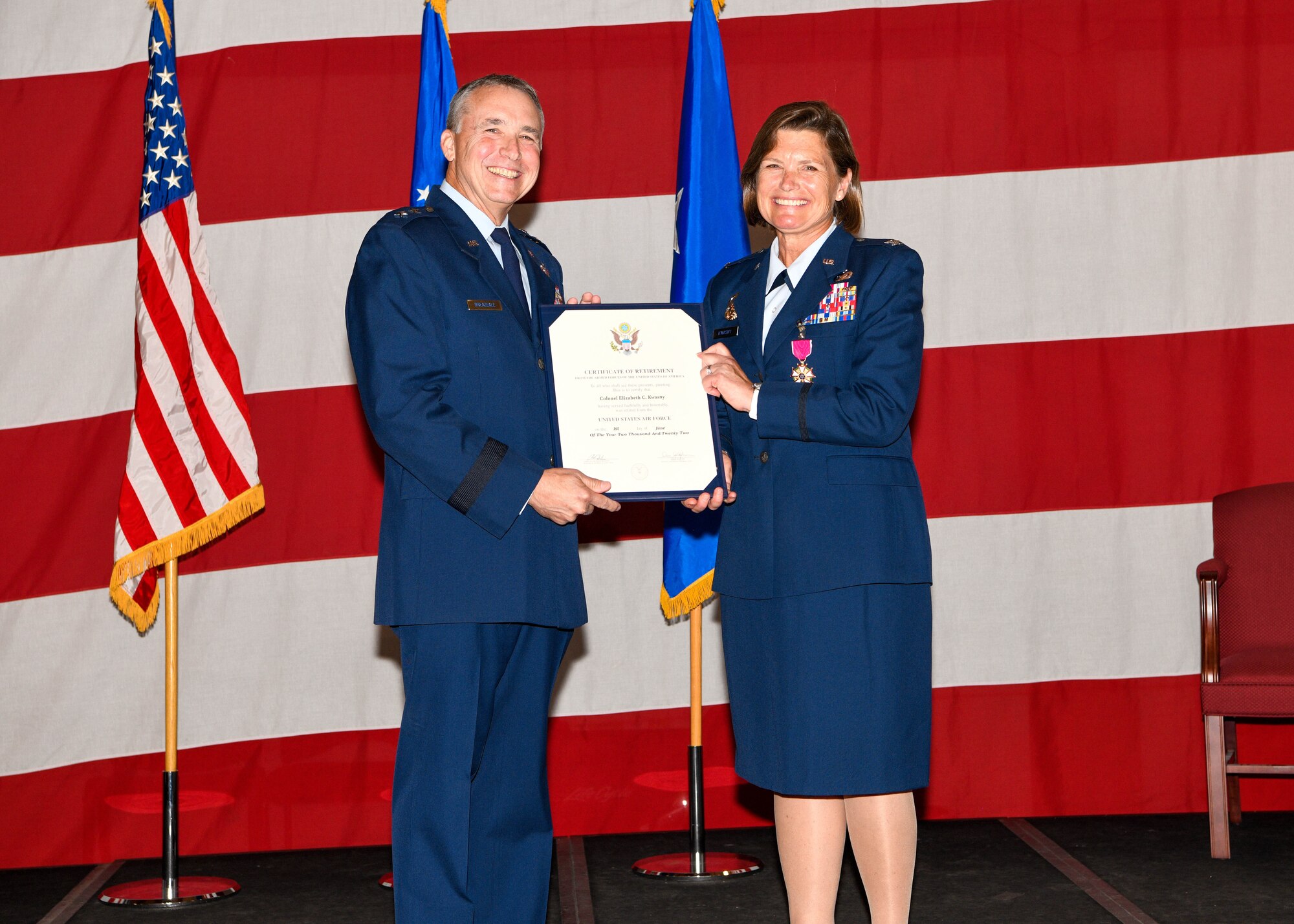 Colonel Elizabeth "Beth" Kwasny accepts a Certificate of Retirement from Major General John Breazeale during a retirement ceremony on Saturday, April 30, 2022 at the Naval Air Station Joint Reserve Base Fort Worth, Texas. Kwasny served 31 years in the United States Air Force, both on Active Duty and as a traditional reservist.