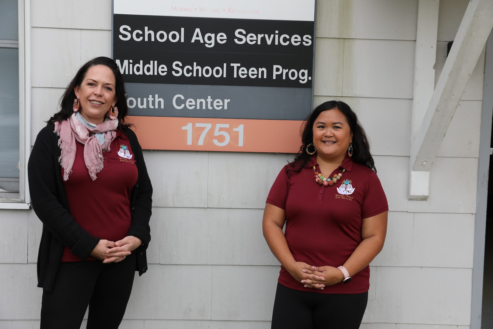 Maj. Rebecca Brawner, left, Department of Defense gender and protection lead advisor at Fort McCoy, and Sharon Feist, chief gender advisor for U.S. Indo-Pacific Command, pose in front of an emergency childcare facility they hope to start on Fort McCoy, Wisconsin, Oct. 11, 2021. The Department of Defense, through U.S. Northern Command, and in support of the Department of Homeland Security, is providing transportation, temporary housing, medical screening, and general support for at least 50,000 Afghan evacuees at suitable facilities, in permanent or temporary structures, as quickly as possible. This initiative provides Afghan evacuees essential support at secure locations outside Afghanistan. (U.S. Army photo by Pfc. Caitlin Wilkins, 50th Public Affairs Detachment)