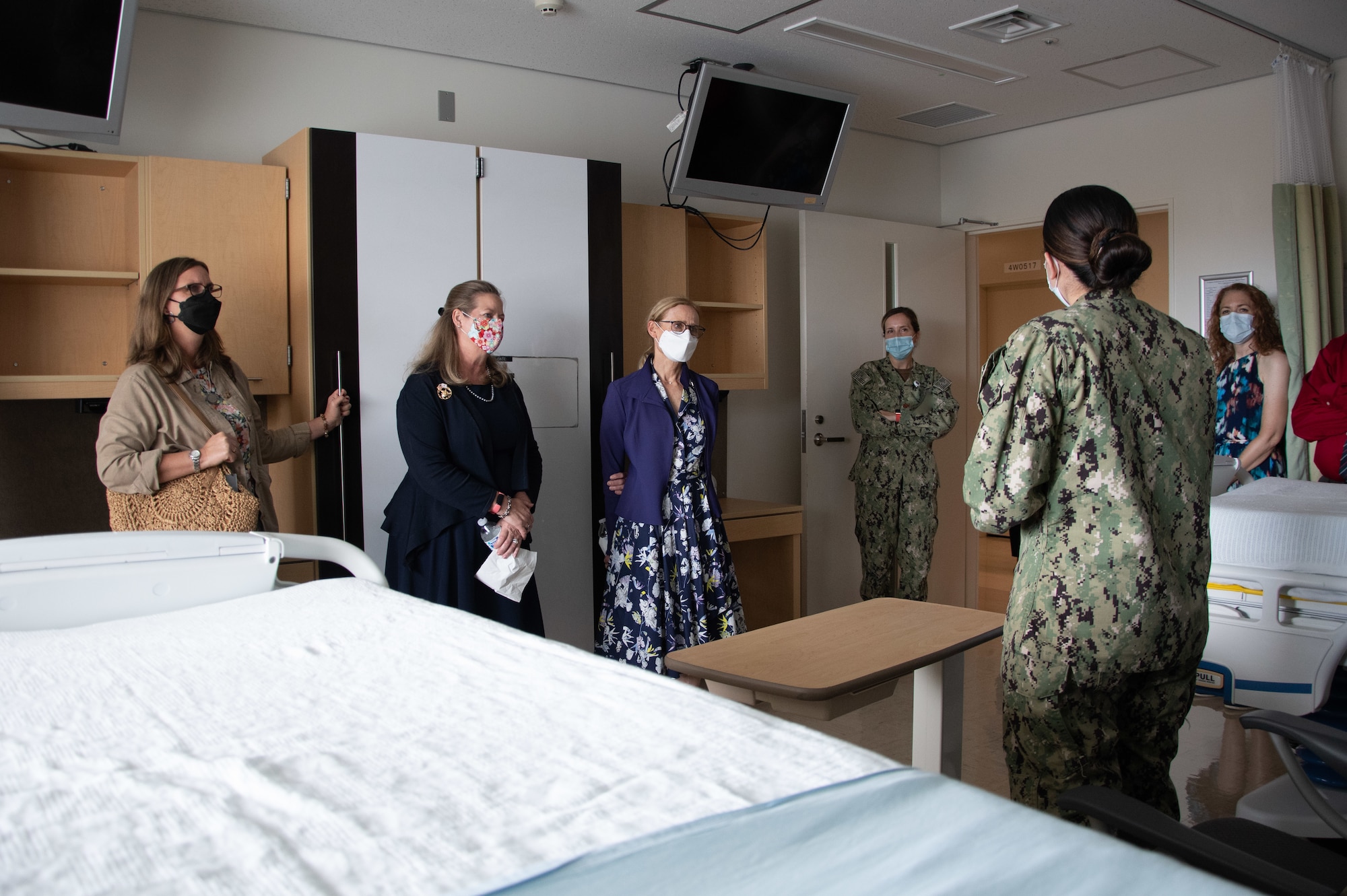 A seaman gives a tour in a hospital room