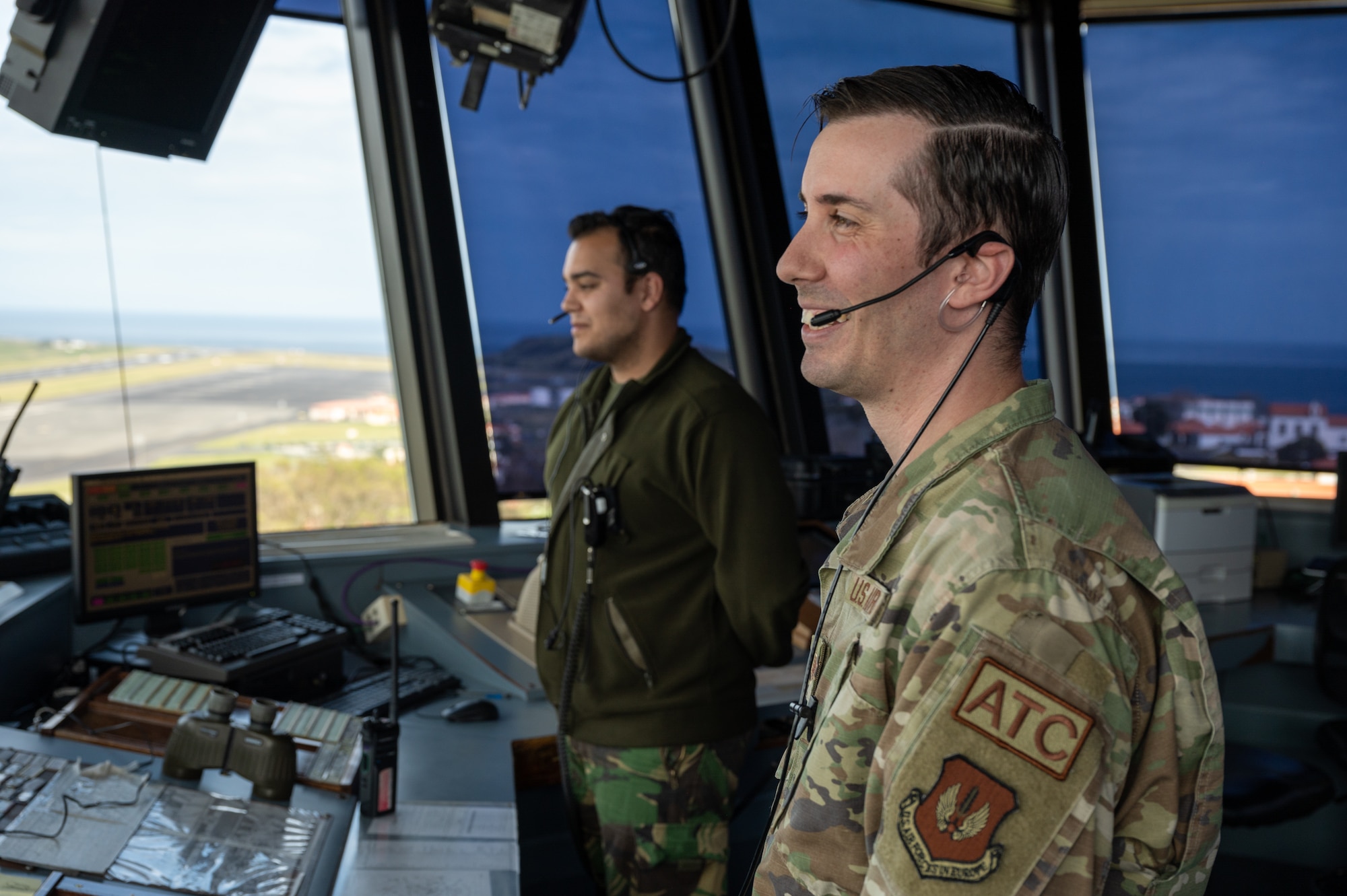 Service members working in an air traffic control tower.