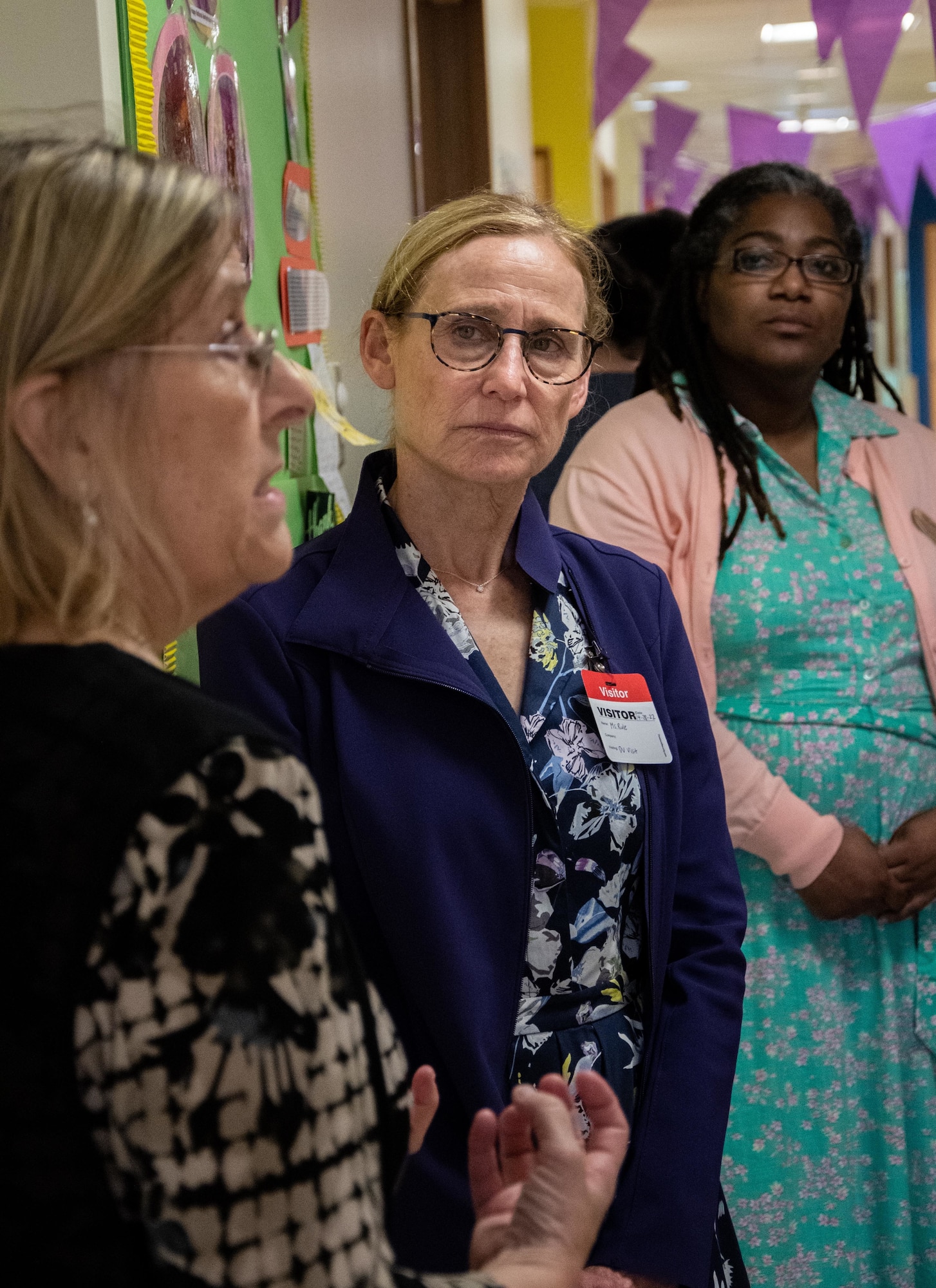 A woman listens to a briefing