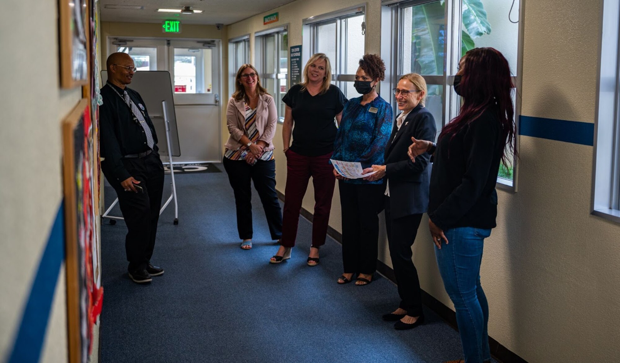 People tour a teen center.