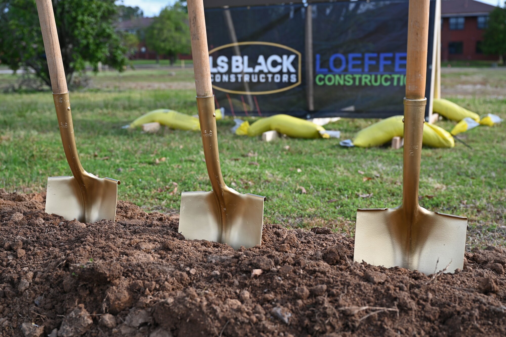A row of shovels rests at the site of a new dormitory construction project during a groundbreaking ceremon