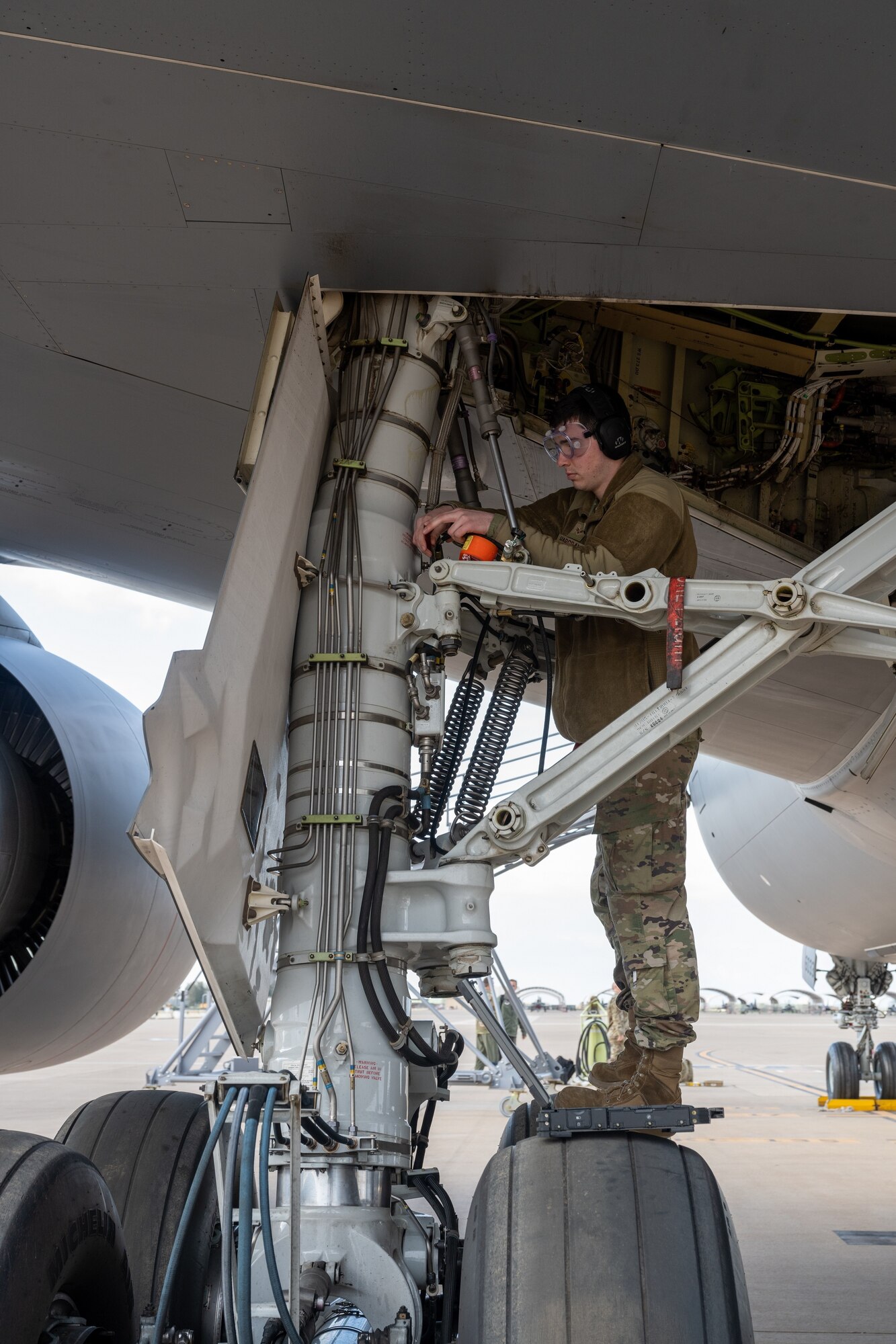 Senior Airman Brandon Hargrave, 22nd Aircraft Maintenance Squadron crew chief, inspects air pressure on the landing gear of a KC-46A Pegasus from McConnell Air Force Base, Kansas, during an Employment Concept Exercise (ECE) March 21, at Morón Air Base, Spain.