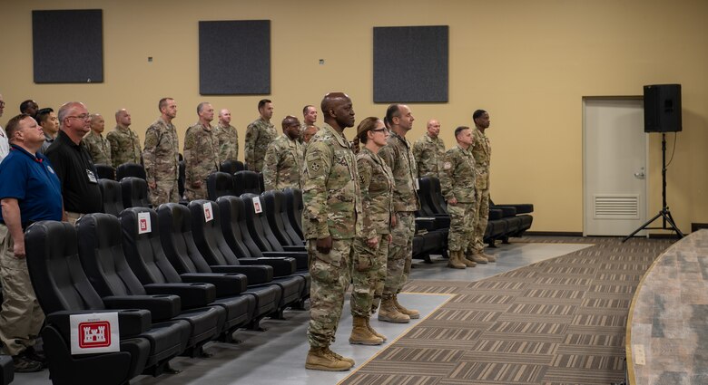 The official party stands and waits for the playing of the national anthem  at the Expeditionary District's Relinquishment of Command ceremony, April 25, 2022, at Camp Arifjan, Kuwait.