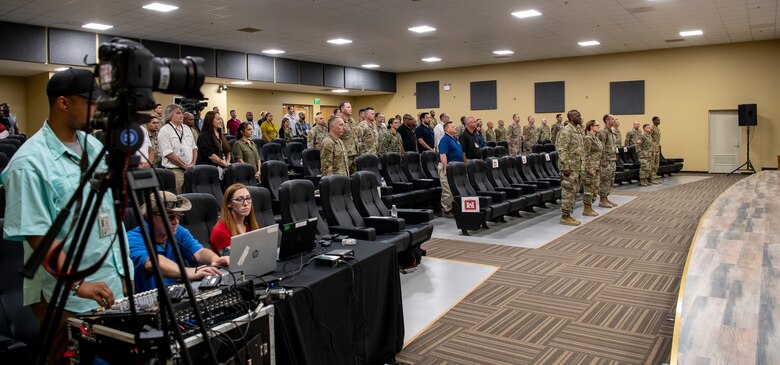 The official party stands and waits for the playing of the national anthem at the Expeditionary District's Relinquishment of Command ceremony, April 25, 2022, at Camp Arifjan, Kuwait.