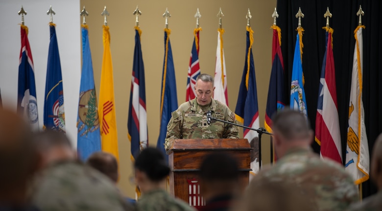 Area Support Group - Kuwait Command Chaplain, Lt. Col. Tracy Hudgins, provides an invocation at the start of the Expeditionary District's Relinquishment of Command ceremony.