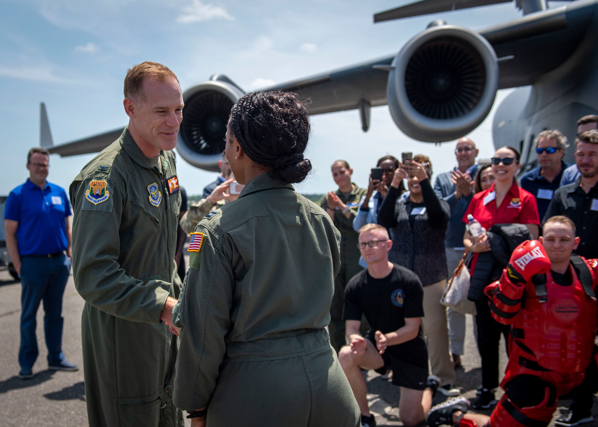 U.S. Air Force Col. Ben Jonsson, 6th Air Refueling Wing commander, recognizes Maj. Rhea McFarland, a pilot assigned to the 14th Airlift Squadron, for her involvement in planning a “flightline rodeo” for civic leaders from the Tampa Bay area at Joint Base Charleston, South Carolina, April 21, 2022. The civic leader group toured the Charleston aircraft, met with Phoenix Ravens and aeromedical evacuation specialists during multi-base field trip to strengthen relations and bolster community support. (U.S. Air Force photo by Airman 1st Class Lauren Cobin)