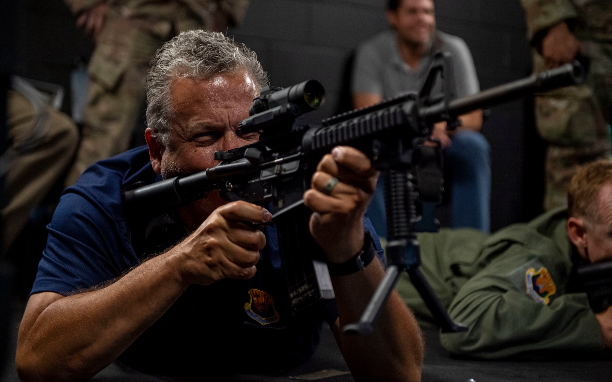Andy Mayts, Air Mobility Command civic leader and partner of Shumaker, Loop and Kendrick LLC, takes aim during a weapons simulation training at the 1st Combat Camera Squadron located at Joint Base Charleston, South Carolina, April 21, 2022. The 1st CTCS is one of two active-duty Combat Camera units in the Air Force and is responsible for collecting imagery in support of strategic operations worldwide. (U.S. Air Force photo by Airman 1st Class Lauren Cobin)