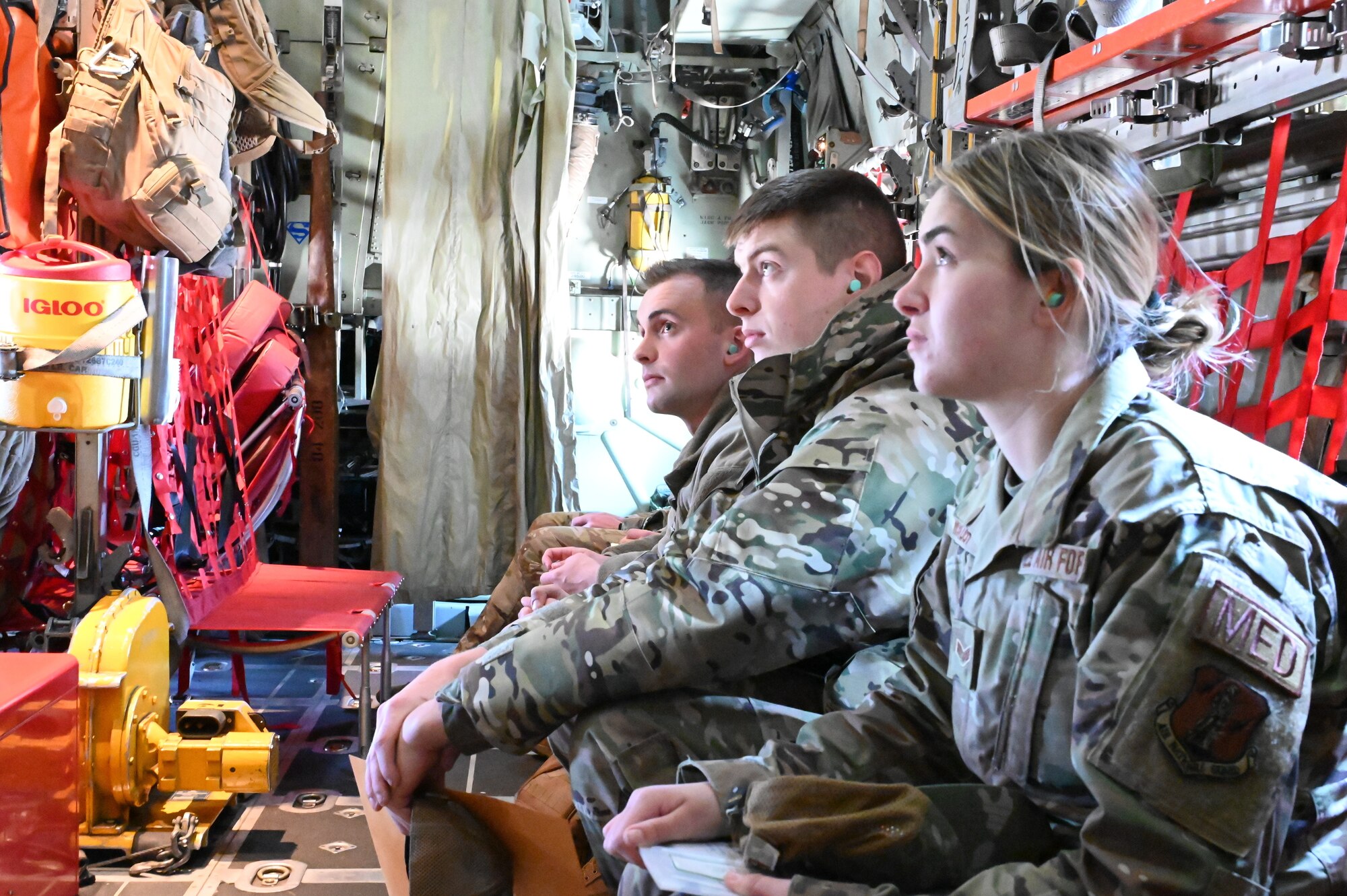 Airmen from the 174th Attack Wing listen to instruction during a ride on a C-130. The flight was intended to simulate a flight to another country and is part of a week-long deployment readiness exercise.  (U.S. Air National Guard photo by Staff Sgt. Duane Morgan)