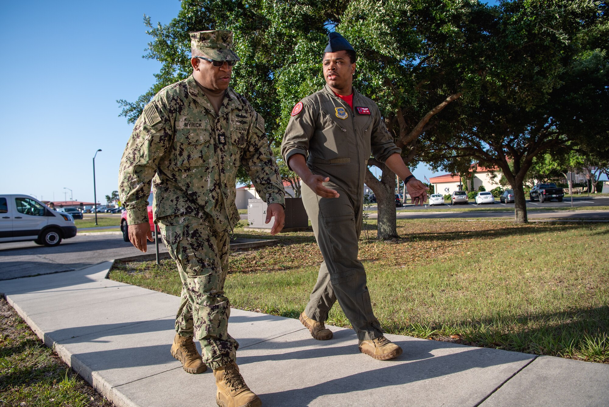 U.S. Air Force Master Sgt. Victor Boyd (right), 6th Operations Group training superintendent, briefs U.S. Navy Fleet Master Chief Donald Myrick, U.S. Transportation Command senior enlisted leader, on flight training during a tour at MacDill Air Force Base, Florida, April 29, 2022. Myrick visited the training section to learn their role in producing qualified and certified crewmembers and how they use simulator training systems to maintain a mission ready force. (U.S. Air Force photo by Staff Sgt. Alexander Cook)