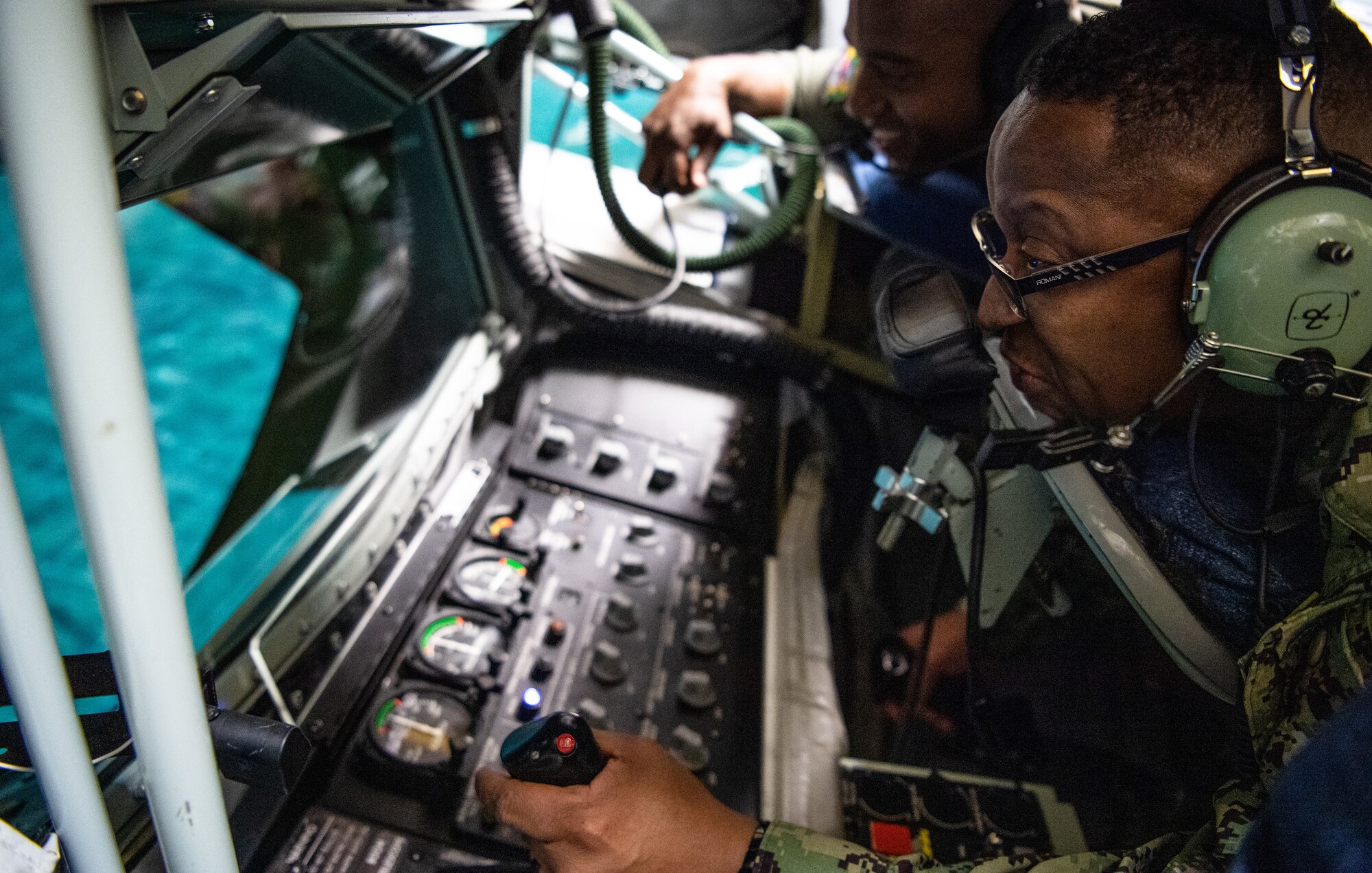 U.S. Navy Fleet Master Chief Donald Myrick, U.S. Transportation Command senior enlisted leader, simulates refueling an aircraft during a tour at MacDill Air Force Base, Florida, April 29, 2022. Myrick visited the training section to learn their role in producing qualified and certified crewmembers and how they use simulator training systems to maintain a mission ready force. (U.S. Air Force photo by Staff Sgt. Alexander Cook)