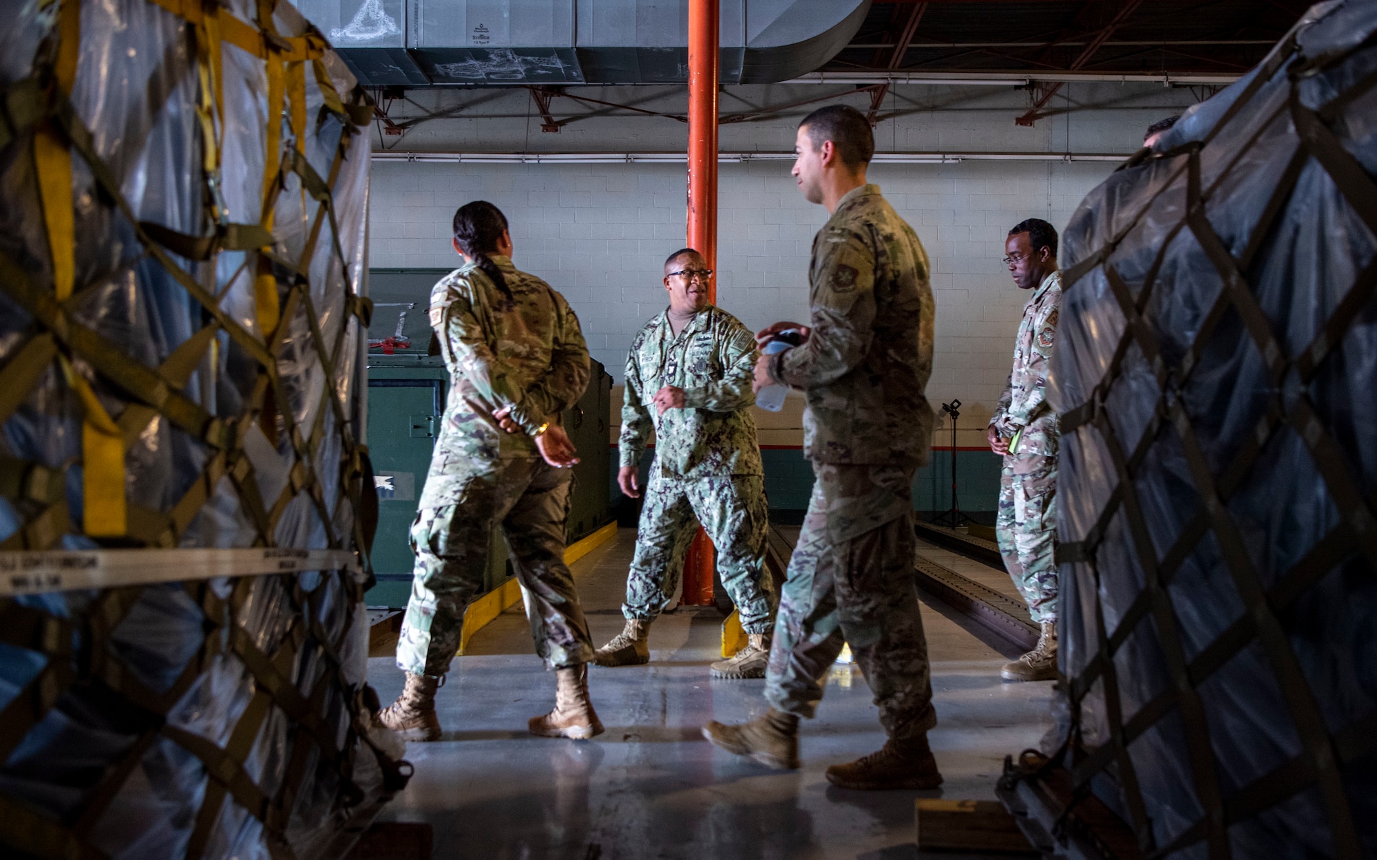 U.S. Navy Fleet Master Chief Donald Myrick, center, U.S. Transportation Command senior enlisted leader, walks through the 6th Logistics Readiness Squadron during a tour at MacDill Air Force Base, Florida, April 29, 2022. Myrick visited the 6th LRS to learn more about their role in supporting large scale readiness operations. (U.S. Air Force photo by Airman 1st Class Lauren Cobin)