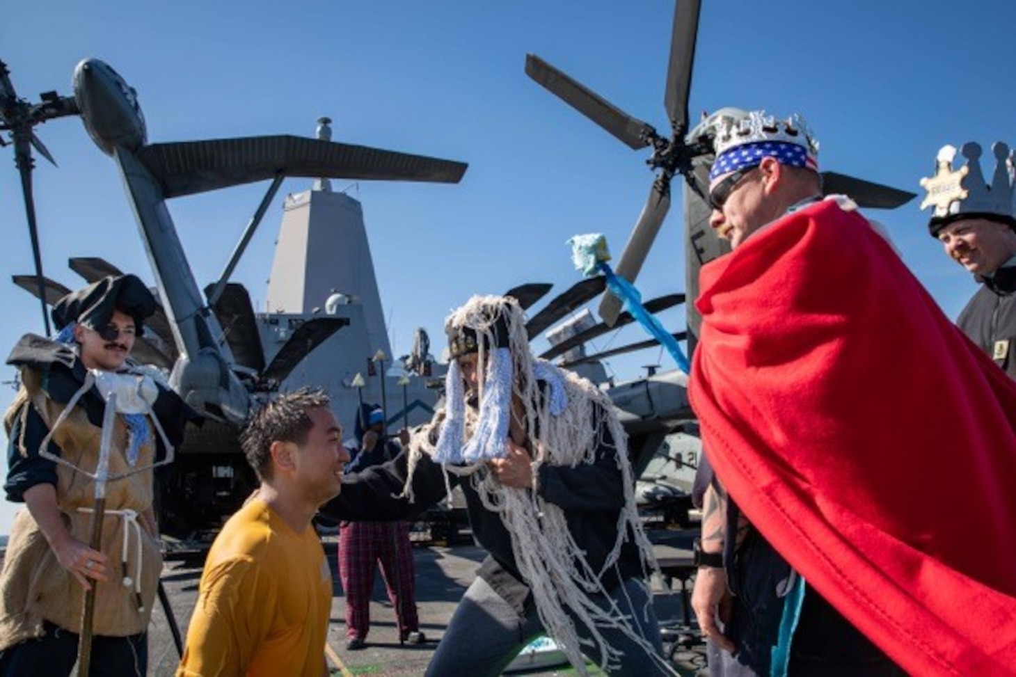 Sailors, assigned to the San Antonio-class amphibious transport dock ship USS Arlington (LPD 24), are welcomed into the “Order of the Blue Nose” during an Arctic Circle ceremony on Arlington’s flight deck, April 22, 2022.