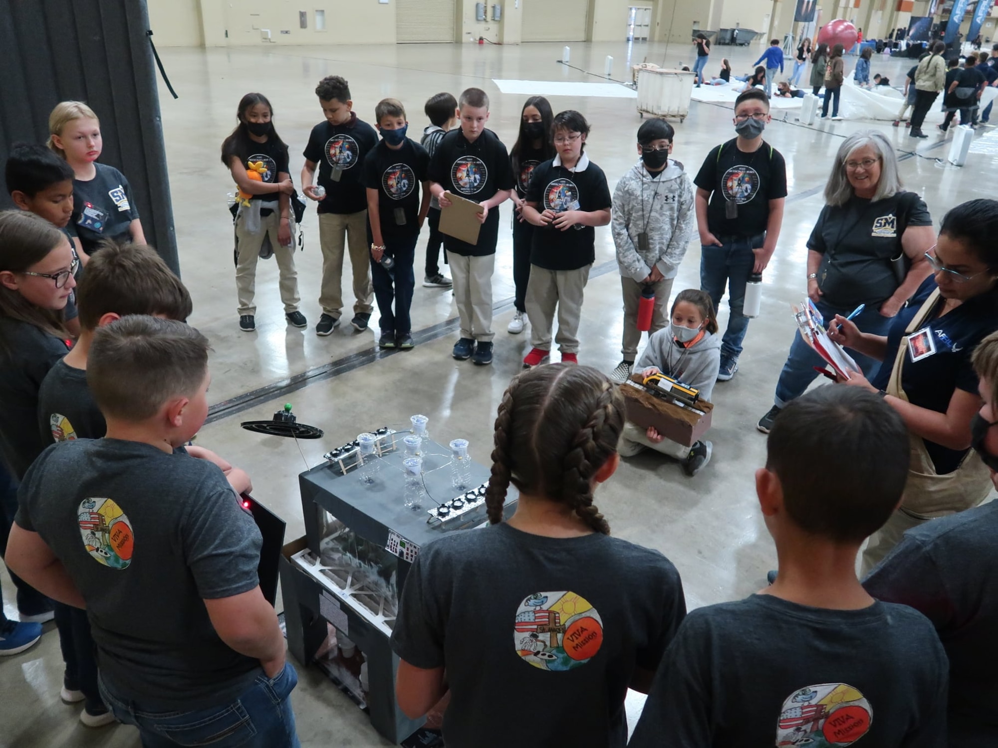 Students give a technical briefing to Air Force Research Laboratory volunteers and fellow students at the AFRL STEM Academy’s Mission to Mars Link-up Day at the Albuquerque Convention Center, April 19, 2022. The briefing includes details about the life support system model they designed and built, and the mission patch they created.