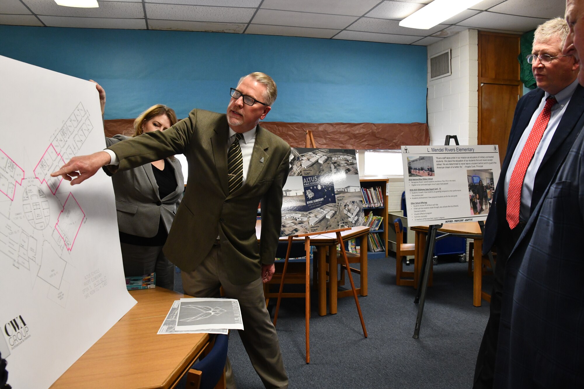 Roe Worbes, Altus Public Schools superintendent, and Judith Mott, 97th Force Support Squadron school liaison program manager, discuss Mendel Rivers Elementary public school on a military installation report with Rep. Frank Lucas, Oklahoma congressman at Altus Air Force Base, Oklahoma, April 22, 2022. Worbes discussed the conditions of local schools and plans to rebuild and improve the learning environment for children at Altus AFB. (U.S. Air Force photo by Airman 1st Class Miyah Gray)