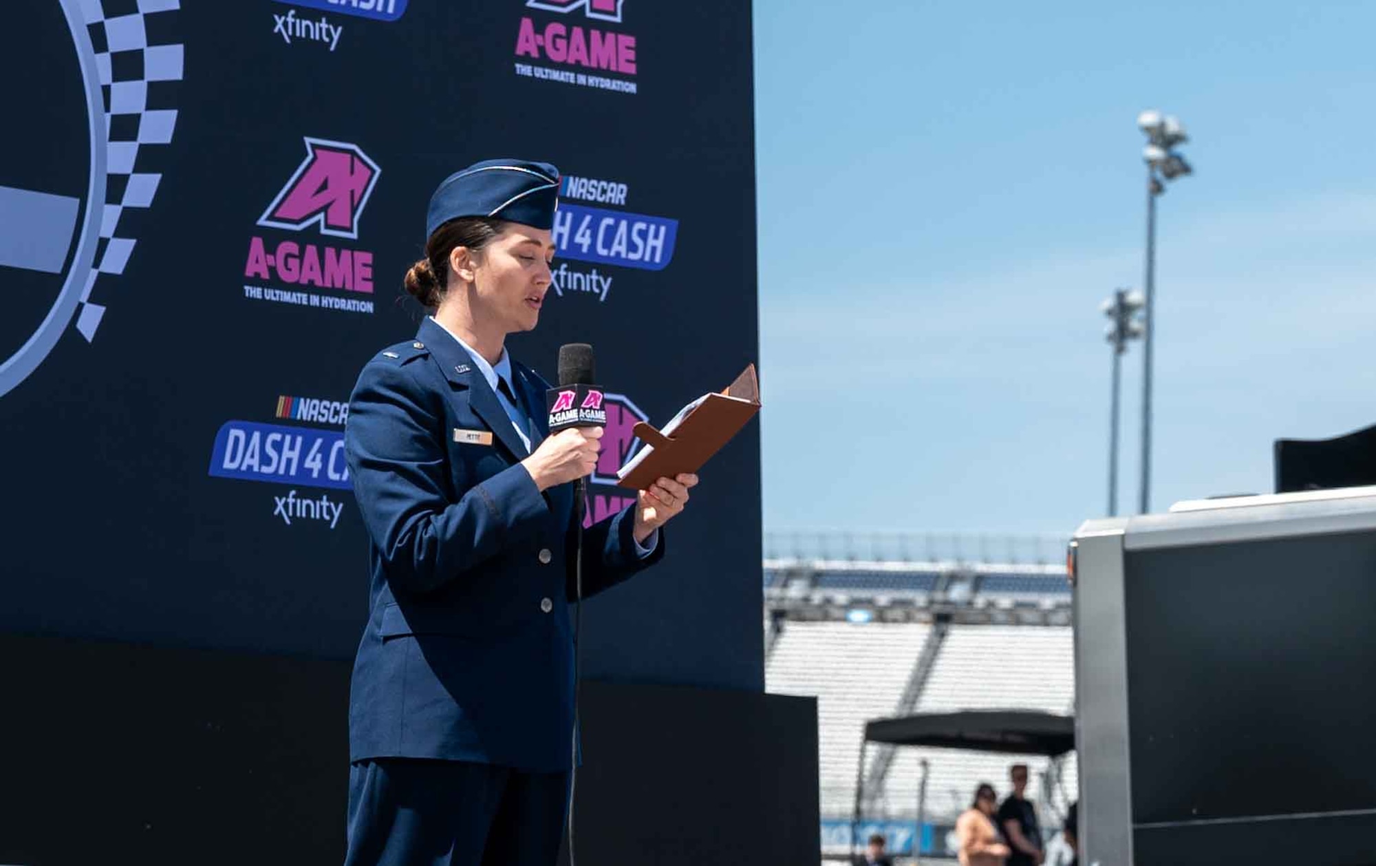 First Lt. Rebecca Petit, 436th Airlift Wing chaplain, gives the invocation before the A-Game 200 NASCAR race at Dover Motor Speedway in Dover, Delaware, April 30, 2022. Petit and the Dover Air Force Base Honor Guard performed during pre-race events throughout the 2022 NASCAR weekend. (U.S. Air Force photo by Senior Airman Faith Schaefer)