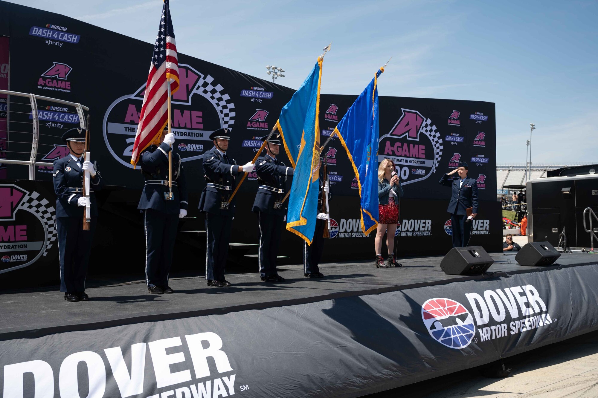 Dover Air Force Base Honor Guard members exit the stage after presenting the colors at the A-Game 200 NASCAR race at Dover Motor Speedway in Dover, Delaware, April 30, 2022. The Honor Guard presented the colors during pre-race events throughout the 2022 NASCAR weekend. (U.S. Air Force photo by Senior Airman Faith Schaefer)