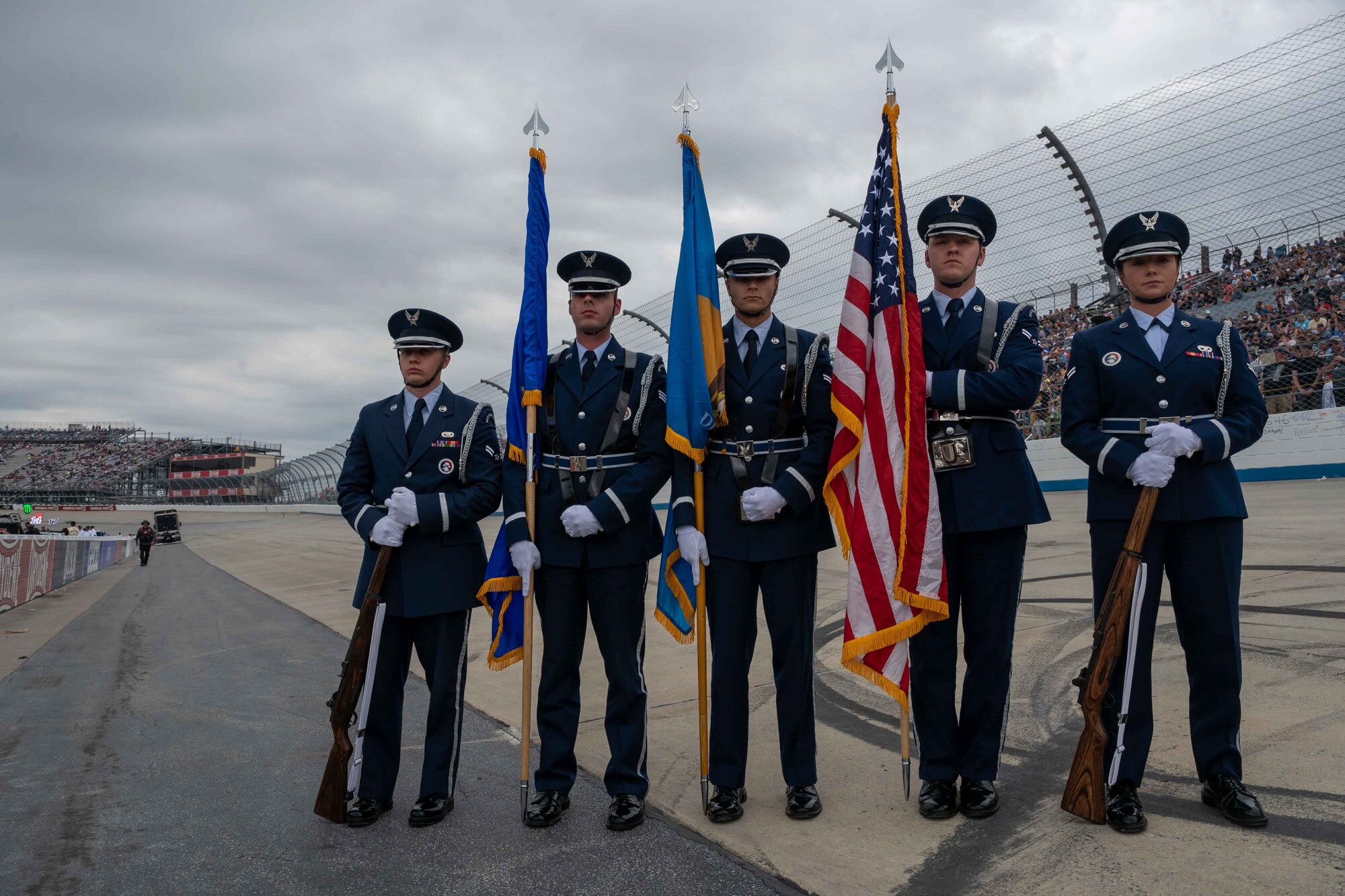 Dover Air Force Base honor guard members wait to present the colors before the Drydene 400 NASCAR race at Dover Motor Speedway in Dover, Delaware, May 1, 2022. The Honor Guard members presented the colors during pre-race events throughout the 2022 NASCAR weekend. (U.S. Air Force photo by Senior Airman Faith Schaefer)