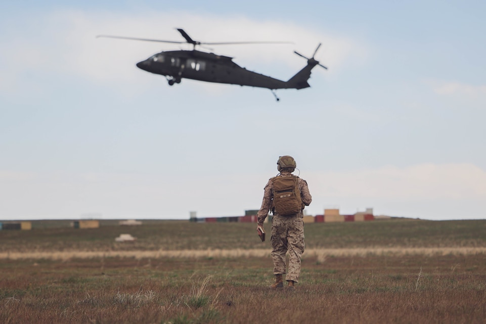 U.S. Marine Corps Capt. Taylor Bussick, a Joint Terminal Attack Controller student with 3rd Battalion, 4th Marine Regiment, 1st Marine Division, awaits an approaching U.S. Army Sikorsky UH-60 Blackhawk at Saylor Creek Range in Grasmere, Idaho during Exercise Garnet Rattler April 28, 2022. Garnet Rattler is a joint training event between Marines, Soldiers and Airmen to train and qualify JTACs to be more efficient and lethal in a realistic training environment.