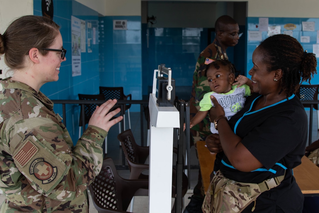Airmen provide medical care to an infant.