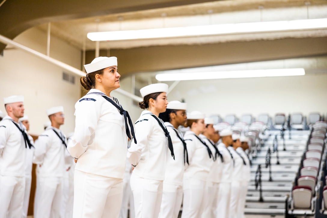 Sailors wearing dress uniforms stand in rows.