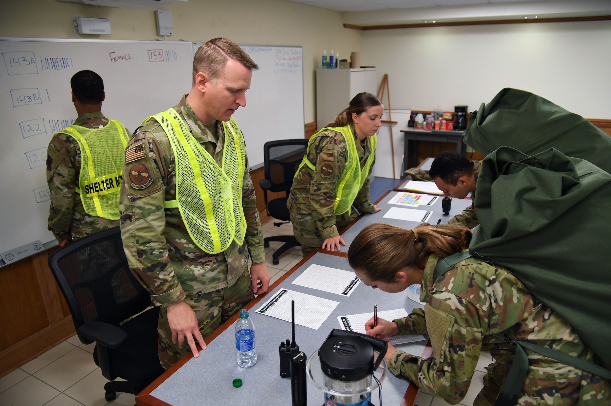 Members of the 335th Training Squadron sheltering team in-process Airmen into the Allee Hall shelter during a hurricane exercise at Keesler Air Force Base, Mississippi, April 29, 2022. Keesler personnel participate in exercise scenarios in preparation for hurricane season. (U.S. Air Force photo by Kemberly Groue)