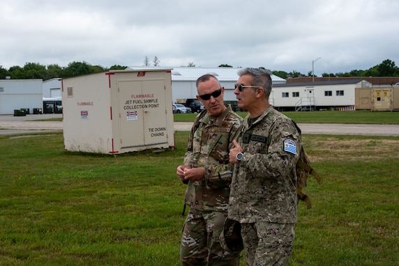 Uruguayan Air Force Col. Ruben Aquines and U.S. Air Force Col. Tom Olander discuss security cooperation en route to a UH-60M Blackhawk at the 1109th TASMG in Groton, Conn. on June 15, 2021. The visit was part of a bilateral State Partnership Program engagement.