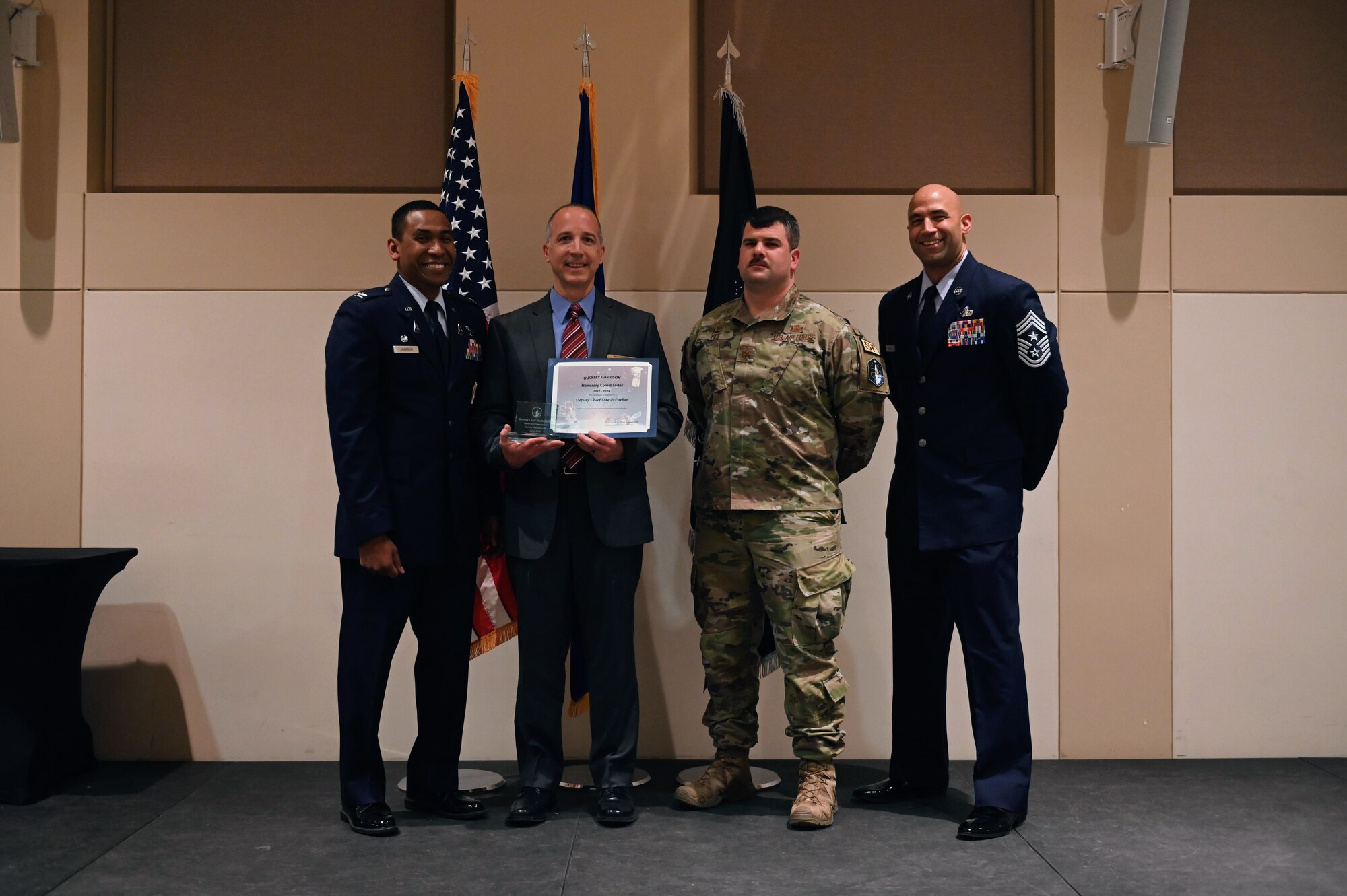 Col. Marcus Jackson, Buckley Garrison commander, welcomes Deputy Chief Darin Parker, Deputy Chief of Police, Aurora Police Department, as a newly inducted member of the Honorary Commander’s Program at Buckley Space Force Base, Colo., March 16, 2022.