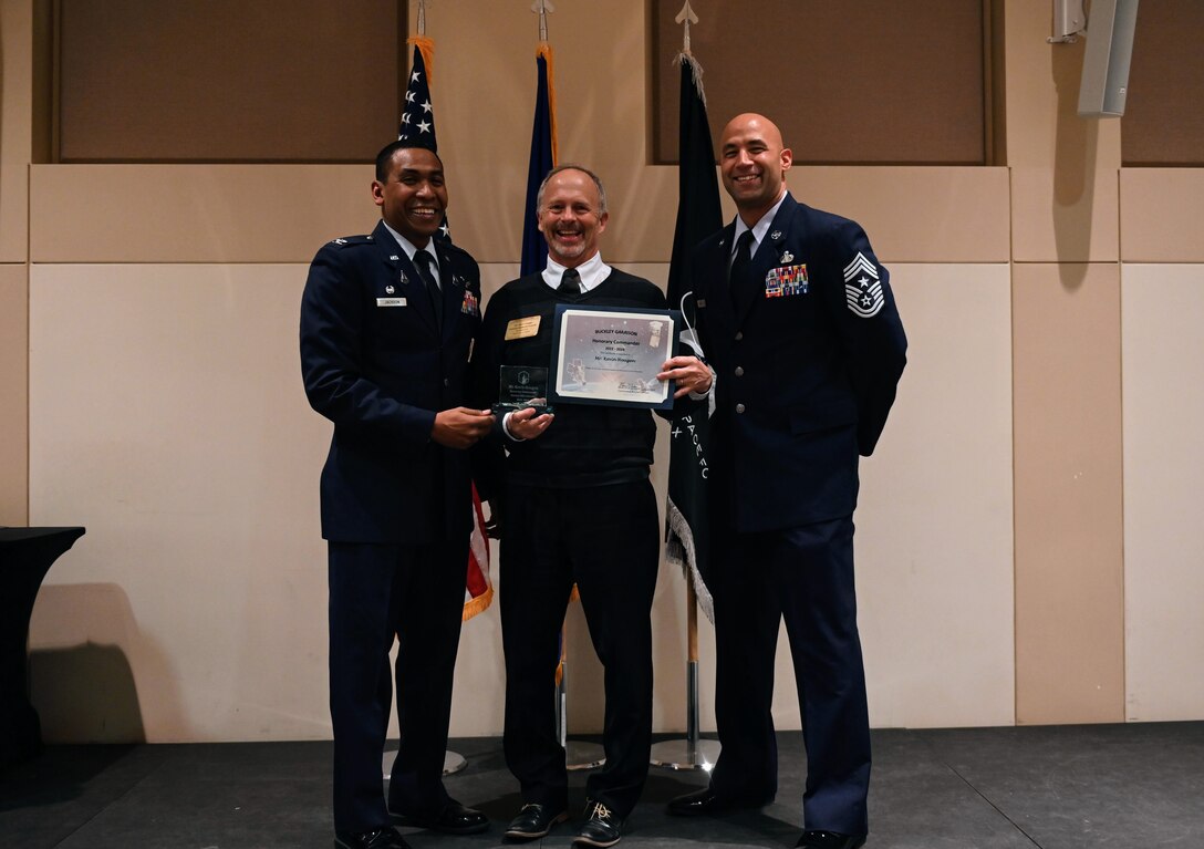 Col. Marcus Jackson, Buckley Garrison commander, welcomes Kevin Hougen, President and CEO, Aurora Chamber of Commerce, as a newly inducted member of the Honorary Commander’s Program at Buckley Space Force Base, Colo., March 16, 2022.