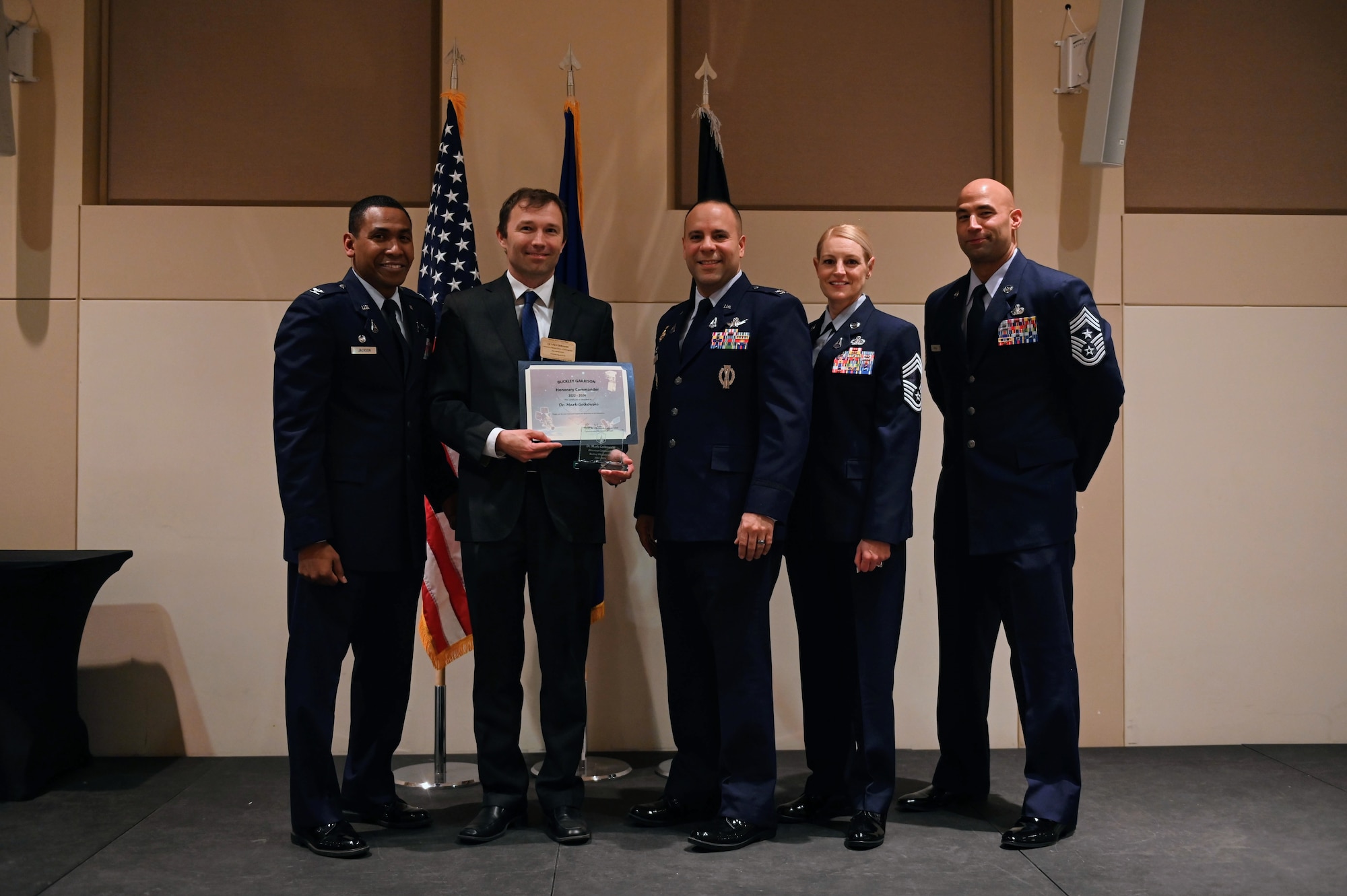 Col. Marcus Jackson, Buckley Garrison commander, welcomes Dr. Mark Golkowski, Associate Dean of Education and Student Success and Professor of Electrical Engineering, UC Denver, as a newly inducted member of the Honorary Commander’s Program at Buckley Space Force Base, Colo., March 16, 2022.