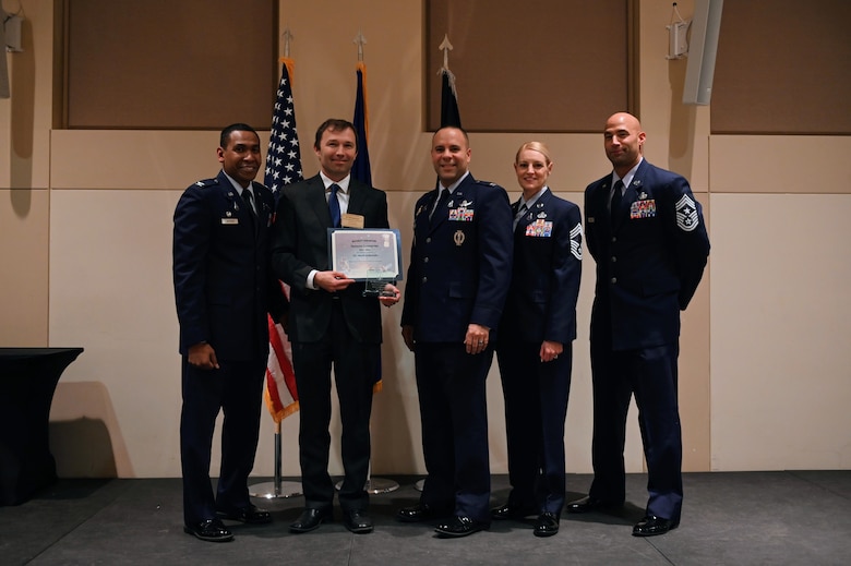 Col. Marcus Jackson, Buckley Garrison commander, welcomes Dr. Mark Golkowski, Associate Dean of Education and Student Success and Professor of Electrical Engineering, UC Denver, as a newly inducted member of the Honorary Commander’s Program at Buckley Space Force Base, Colo., March 16, 2022.