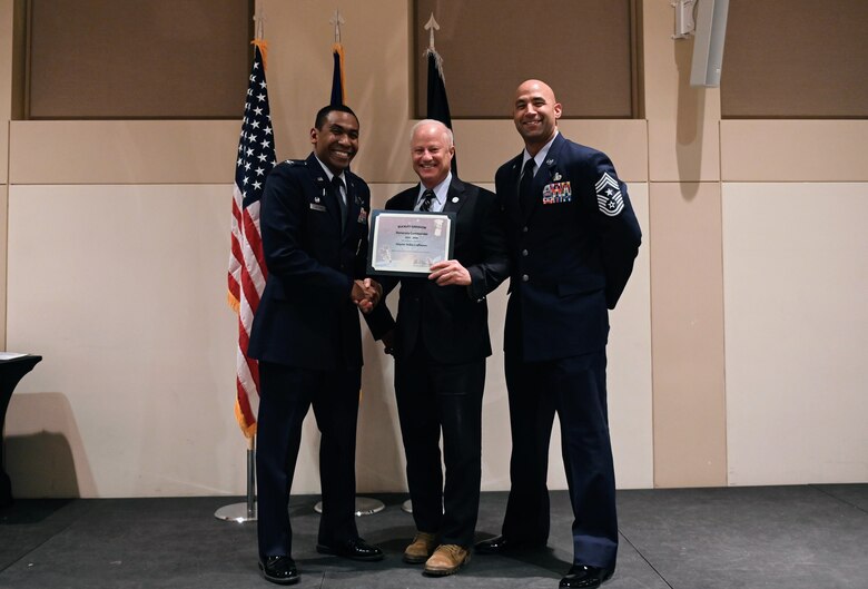 Col. Marcus Jackson, Buckley Garrison commander, welcomes Mike Coffman, the mayor of Aurora, as a newly inducted member of the Honorary Commander’s Program at Buckley Space Force Base, Colo., March 16, 2022