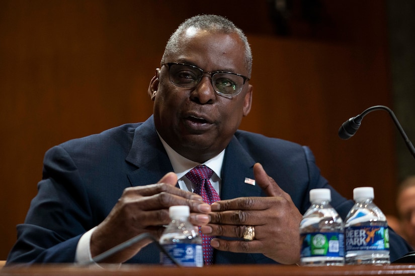 A man speaks at a podium.