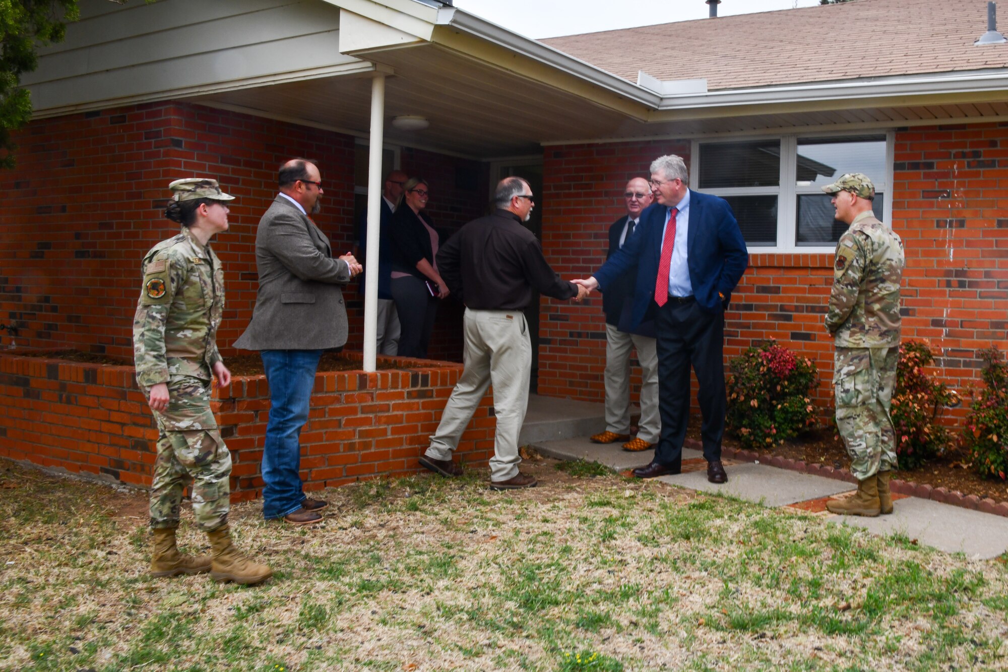 Rep. Frank Lucas, Oklahoma congressman, greets Capehart housing community representatives at Altus Air Force Base, Oklahoma, April 22, 2022. The team visited homes on base to discuss plans for future construction and renovation projects during a tour with the 97th Air Mobility Wing. (U.S. Air Force photo by Airman 1st Class Miyah Gray)