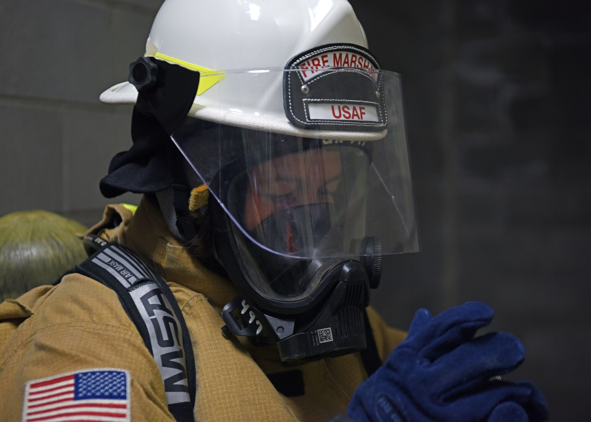 U.S. Air Force Col. Angelina Maguinness , 17th Training Group commander, prepares to enter the enclosed space trainer at the Louis F. Garland Department of Defense Fire Academy, Goodfellow Air Force Base, Texas, April 20, 2022. Potential civil engineer squadron commanders attended the course to understand better the firefighters they lead. The Fire Marshal course was designed to provide insight on the numerous responsibilities and challenges within Department of Defense Fire and Emergency Services to civil engineer commanders. (U.S. Air Force photo by Senior Airman Ethan Sherwood)