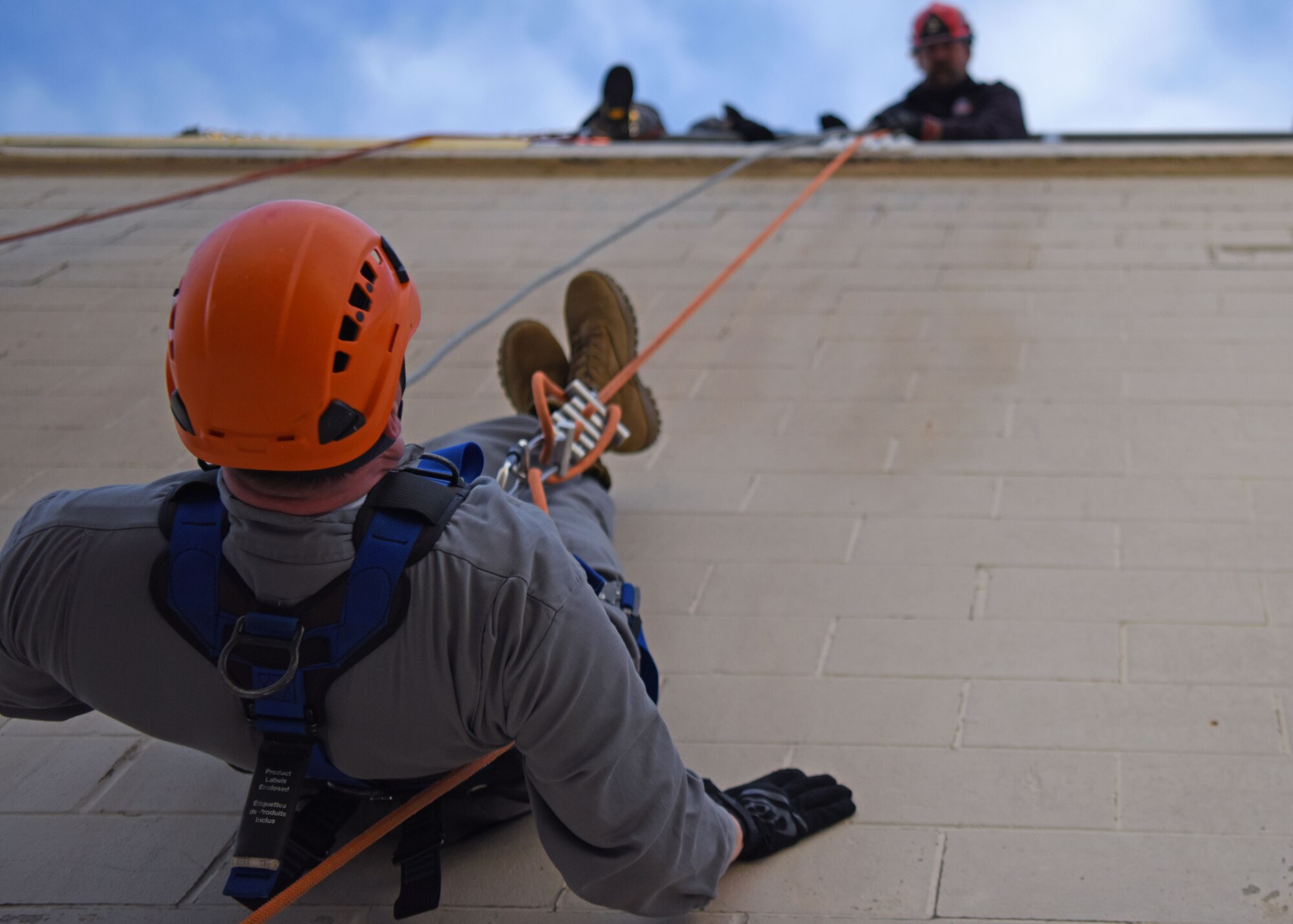 A fire marshal inverts while repelling at the Louis F. Garland Department of Defense Fire Academy, Goodfellow Air Force Base, Texas, April 20, 2022. The Fire Marshal  course was three days, going over the structure of the department, practical exercises, and other functions of fire departments. The Fire Marshal course was designed to provide insight on the numerous responsibilities and challenges within Department of Defense Fire and Emergency Services to future civil engineer commanders. (U.S. Air Force photo by Senior Airman Ethan Sherwood)