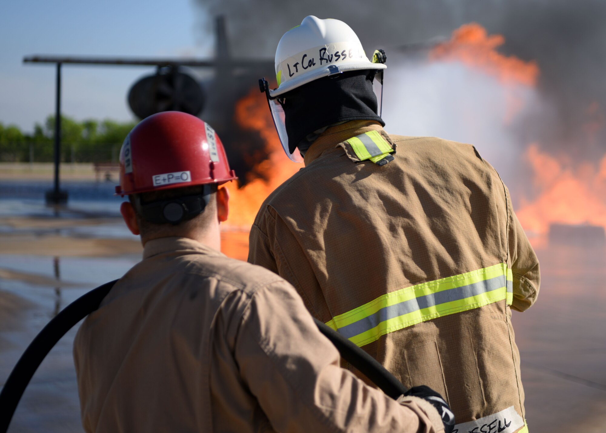 U.S. Air Force Lt. Col Mark Russell, U.S. Air Force Academy Assistant Professor of Civil & Environmental Engineering, suppresses an aircraft fire at the Louis F. Garland Department of Defense Fire Academy, Goodfellow Air Force Base, Texas, April 20, 2022. Fire marshals were shown how to control the hose and used it in a practical exercise to extinguish a fire. The Fire Marshal course was designed to provide insight on the numerous responsibilities and challenges within Department of Defense Fire and Emergency Services to future civil engineer commanders. (U.S. Air Force photo by Senior Airman Ethan Sherwood)