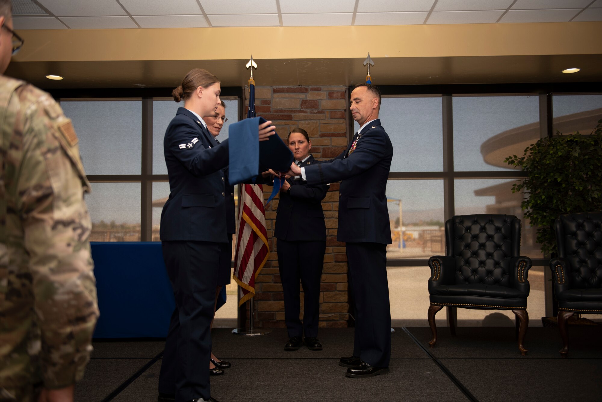 Personnel from the 49th Medical Group furl and case the guidon during the 49th Medical Support Squadron inactivation ceremony April 29, 2022, on Holloman Air Force Base, New Mexico.