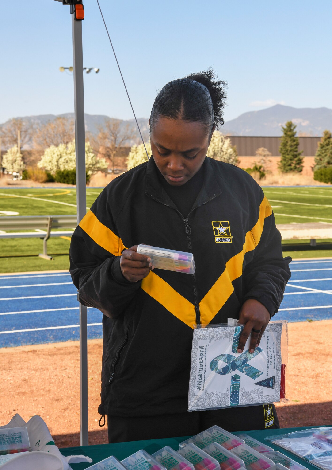 Woman in U.S. Army jacket looking at paper