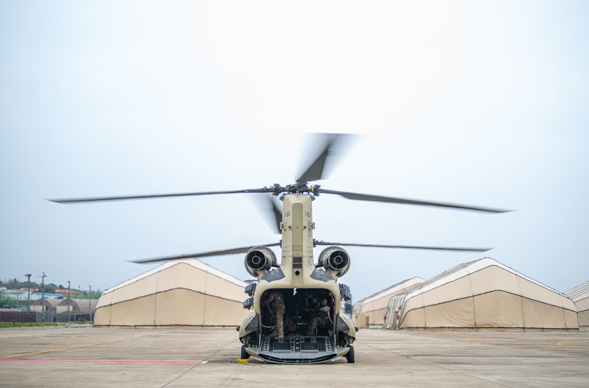 A CH-47 Chinook helicopter, assigned to Bravo Company, 3-2 General Support Aviation Battalion, out of Camp Humphreys, Republic of Korea, prepares for take-off during a K-9 medical evacuation training event at Kunsan Air Base, ROK, April 26, 2022. Military working dog (MWD) teams from the 8th Security Forces Squadron participated in the joint medevac training with units from Camp Humphreys, to observe and calculate the steps needed to properly. (U.S. Air Force photo by Staff Sgt. Gabrielle Spalding)