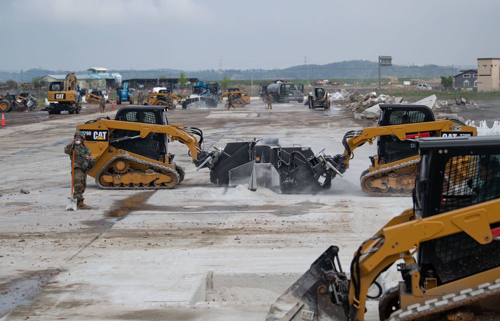 Republic of Korea and U.S. Air Force members fill a simulated crater with water and concrete during Rapid Airfield Damage Repair (RADR) training at Kunsan Air Base, ROK, April 26, 2022.