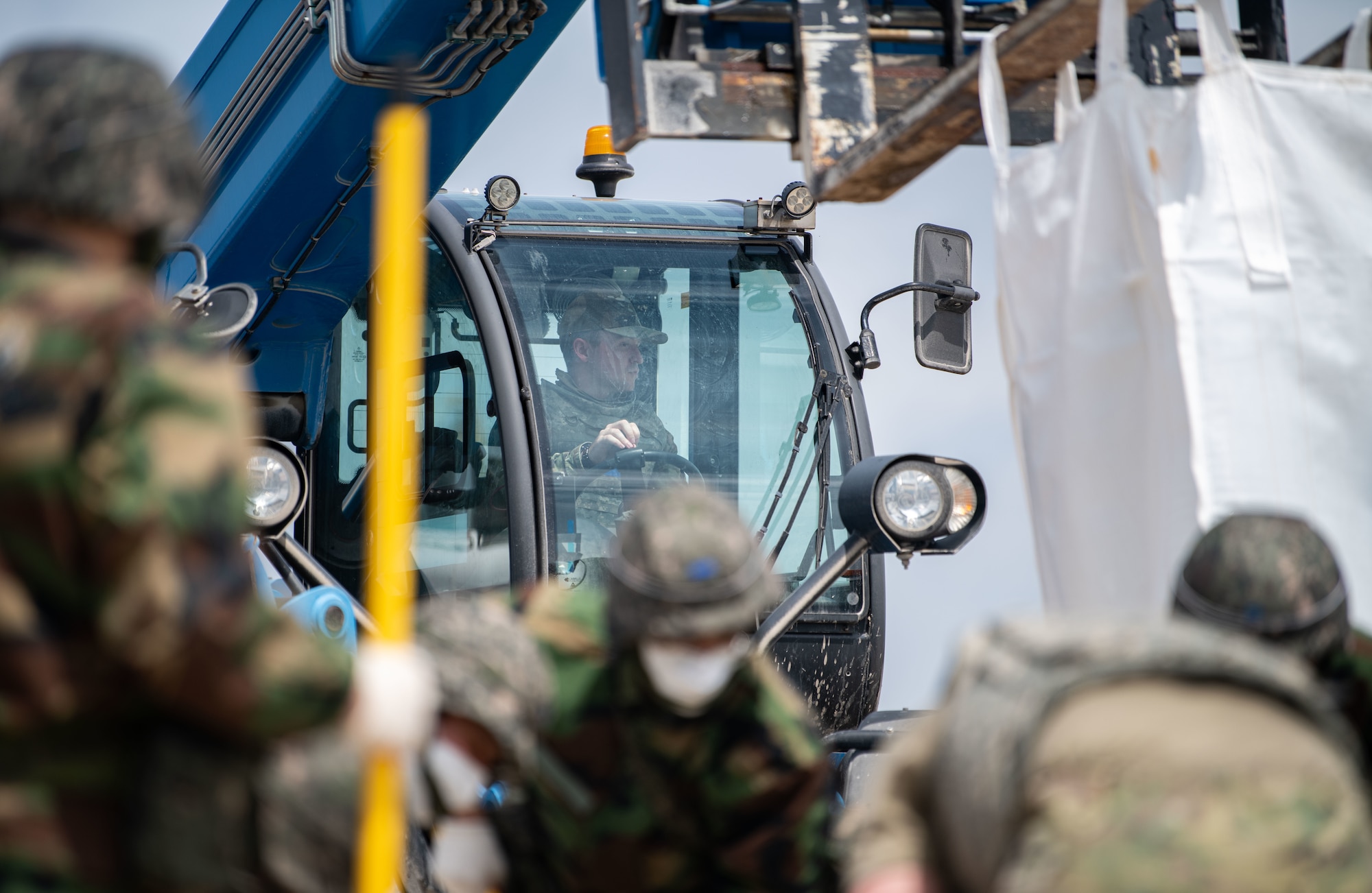 Republic of Korea and U.S. Air Force members fill a simulated crater with water and concrete during Rapid Airfield Damage Repair (RADR) training at Kunsan Air Base, ROK, April 26, 2022.