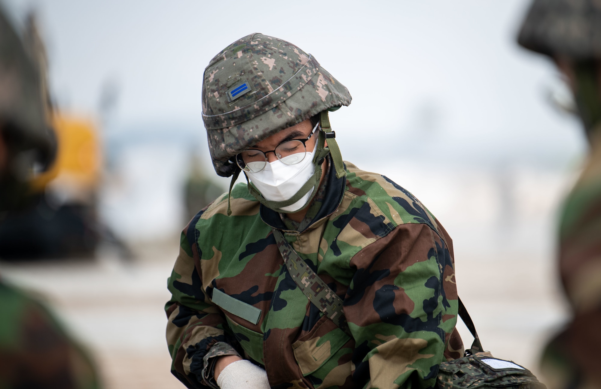 Republic of Korea and U.S. Air Force members fill a simulated crater with water and concrete during Rapid Airfield Damage Repair (RADR) training at Kunsan Air Base, ROK, April 26, 2022.