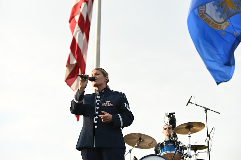 U.S. Air Force Tech. Sgt. Nadia Sosnoski, member of The United States Air Force Band’s Max Impact, sings America the Beautiful during the U.S. Air Force’s 75th Birthday Celebration Spring Tattoo on the Air Force Ceremonial Lawn at Joint Base Anacostia-Bolling, Washington, D.C., May 3, 2022. The key features of the Tattoo included performances by The United States Air Force Band and U.S. Air Force Honor Guard. The members of the Band and Honor Guard share a common mission of representing the values of the Air Force and helping to foster a community across our nation and with our international allies.  (U.S. Air Force photo by Airman 1st Class Anna Smith)