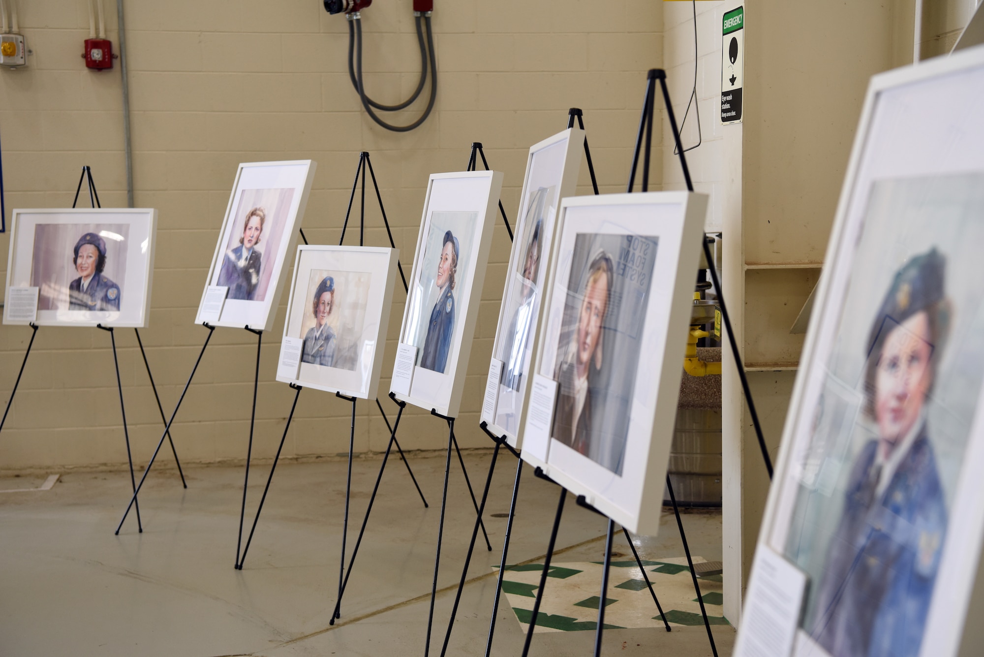 Painted portraits of past Women Airforce Service Pilots line the hangar at Dyess Air Force Base, Texas, April 29, 2022. Many of the WASPs historical significance to wartime contributions were classified for 35 years after the war, but WASPs were prominent in missions such as moving aircraft from factories to bases in need. (U.S. Air Force Photo by Senior Airman Sophia Robello)